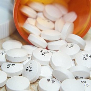 prescription bottle with pills pouring out