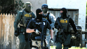 Drug Enforcement Administration Special Agents leave a housef Friday, Sept. 23, 2011, in Roswell, N.M., as part of an investigation that included the arrest of dozens of suspected drug traffickers Friday. (AP Photo/Roswell, Daily Record, Mark Wilson)