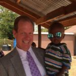 Steven Henson, MD holding an African child on a mission trip