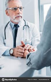 Doctor holding patient's hand