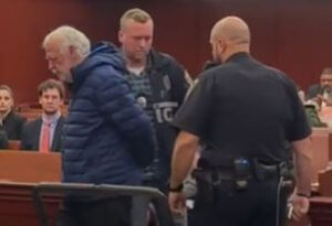 Dr. Noel Smith led into court handcuffed